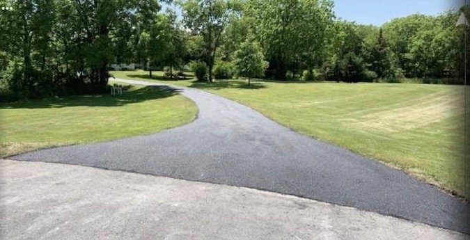 Curved entry driveway with fresh asphalt in Martinsburg, WV